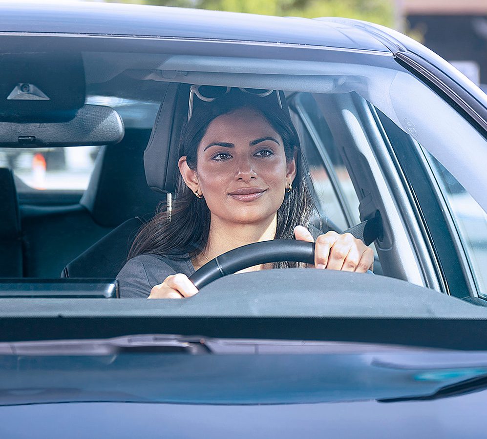 A woman behind the wheel of a vehicle