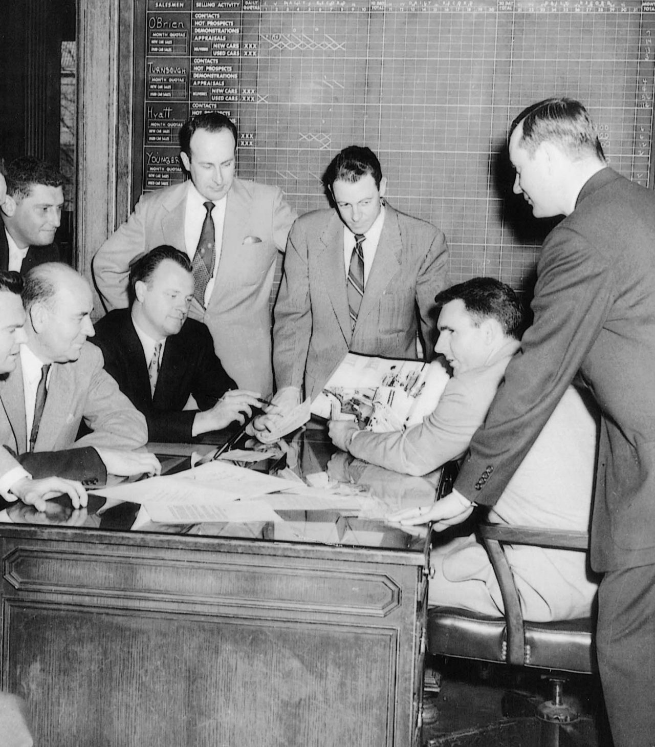 Founder Jack Taylor leads a meeting with a group in 1957