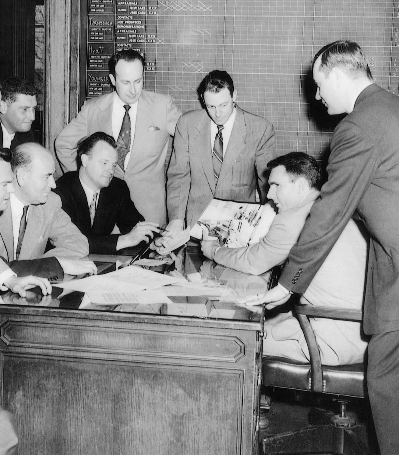 Founder Jack Taylor leads a meeting with a group in 1957