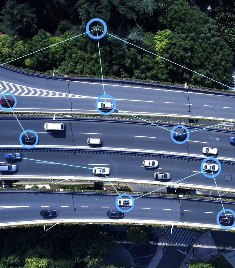 An aerial shot of several cars on the interstate with icons throughout