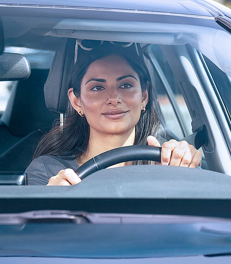 A woman behind the wheel of a vehicle